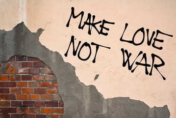 Handwritten graffiti Make Love Not War sprayed on the wall, anarchist aesthetics 