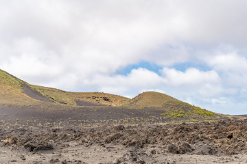 Lanzarote Island one of seven Canary Islands in Atlantic Ocean. Extraordinary volcano landscape with black and reddish rocks, soils and rugged lava formations, for travel and nature blog, magazines