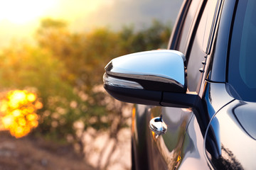 Black car side mirror with sun light effect. Travel and adventure concept. © structuresxx