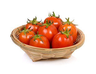 Fresh red tomatoes in a basket on a white background