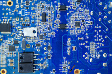 Blue electronic circuit board close-up with different microeleme