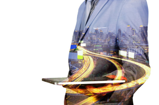 Double exposure of a businessman and a city using a tablet