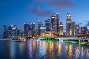 Fototapeta na wymiar Colorful Singapore business district skyline after sun set at Marina Bay.
