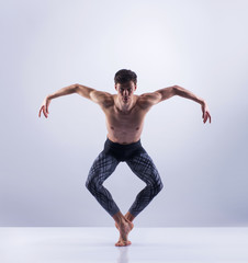 Athletic ballet dancer performing in a studio