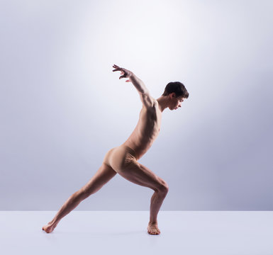 Athletic ballet dancer performing in a studio