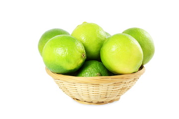 fresh lemon lime citrus fruit in bamboo basket in white background
