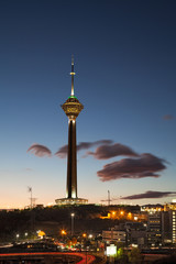 Milad Tower in the Skyline of Tehran at Dusk Against Cloudy Blue Sky