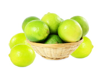 fresh lemon lime citrus fruit in bamboo basket in white background