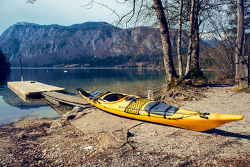 Yellow kayak on the mountain lake