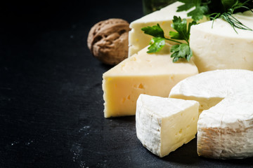 Cheese Assortment on a dark background, selective focus