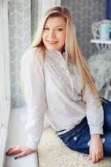 Fototapeta premium beautiful girl in white at the window