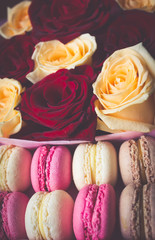 Macaroon and box with flowers roses background
