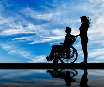 Silhouette of disabled person with a guardian