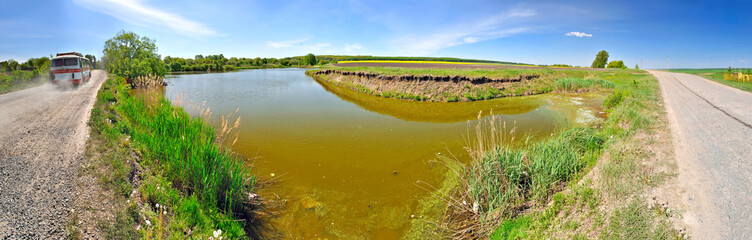 bus rides dirt road in the village