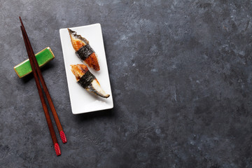 Set of unagi sushi and chopsticks