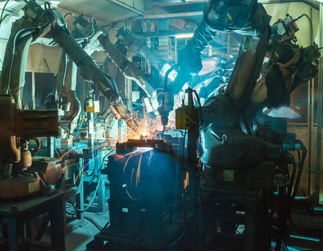 Team welding robots movement in a car factory