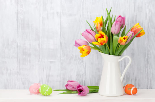 Easter eggs and colorful tulips bouquet