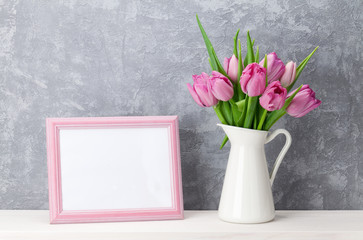 Fresh pink tulip flowers and photo frame