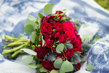 Bright marsala bouquet with blue scarf on green grass