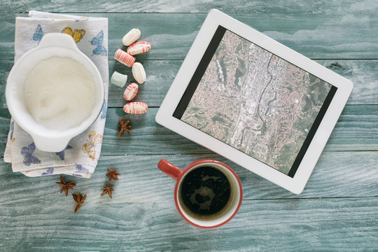 Coffee and tablet on colorful rough wooden table
