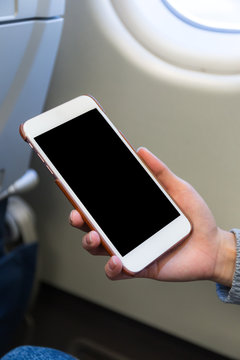Woman use of mobile phone in plane