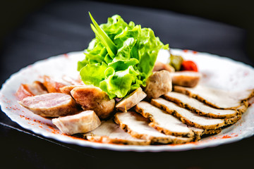Cutting meat and sausages, spices and herbs, a dish in a restaurant