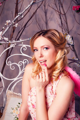 Young beautiful woman in angel costume with pink wings