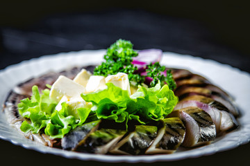 chopped roasted and pickled herring with onions cheese and herbs