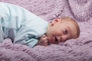 Surprised newborn baby looking up