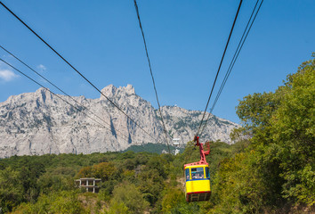 The cable car in Crimea Ai-Petri on a background of mountains covered with clouds