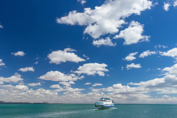 Pleasure boat is mooring to a small pier on a Black Sea shore, Crimea, Ukraine.