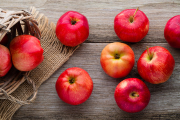 Ripe red apples on wooden background.