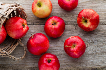 Ripe red apples on wooden background.