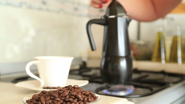 Classic italian coffee maker, moka pot retro with coffee beans and mug
