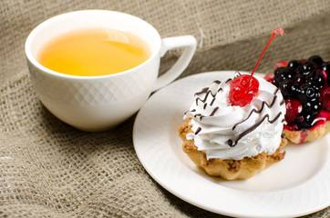 Cup of green tea and cakes