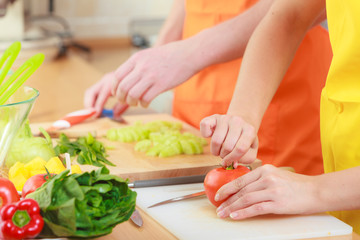 Couple preparing fresh vegetables food salad