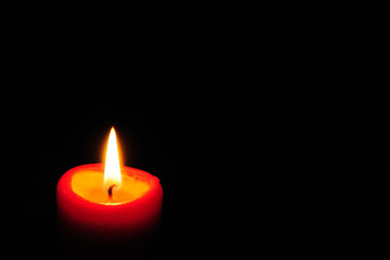 Red candle light with black background