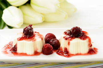 Panna cotta with cherry and cherry sauce. Selective focus.