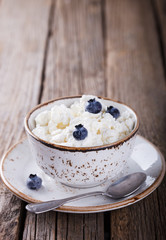 Homemade cottage cheese in a plate, with blueberries.Breakfast.Healthy food.selective focus.