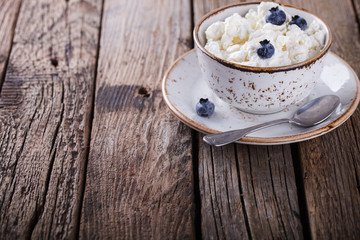 Homemade cottage cheese in a plate, with blueberries.Breakfast.Healthy food.Copy space.selective focus.