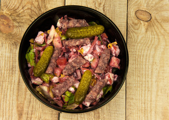 Mix salad with Feta cheese on a wooden countertop