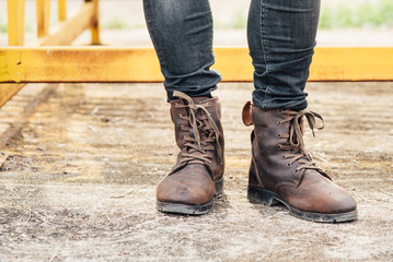 Men fashion legs in black jeans and brown leather boots