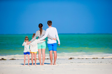 family vacation on white beach