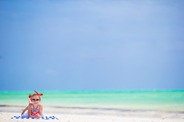 Adorable little girl at beach during summer vacation