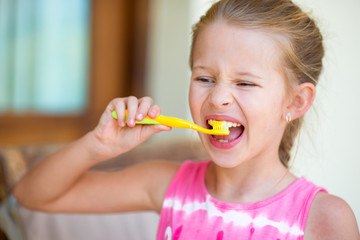 Dental hygiene. Adorable little smile girl brushing her teeth