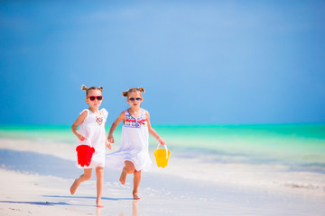 Adorable little girls have fun on the beach