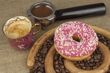 Fresh coffee and a donut. Sweet treats to hot coffee. Traditional dessert, filled donut.
