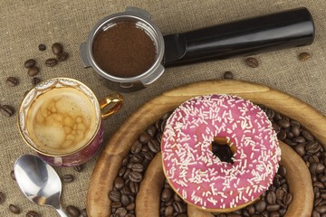 Fresh coffee and a donut. Sweet treats to hot coffee. Traditional dessert, filled donut.
