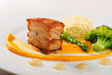 Plated freshly grilled pork bellies with vegetable