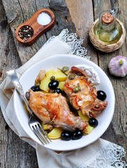 Roast rabbit in white wine with rosemary, olives and capers